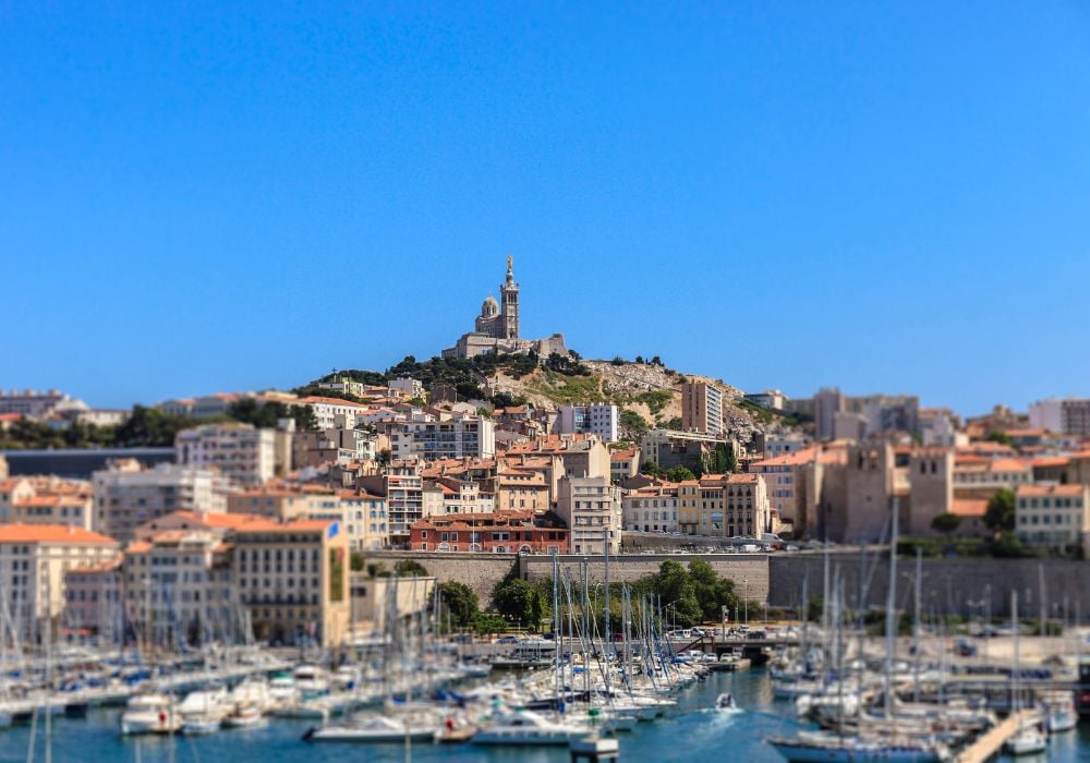 The gorgeous Marseille Old Port with yachts and Basilica of Notre-Dame de la Garde