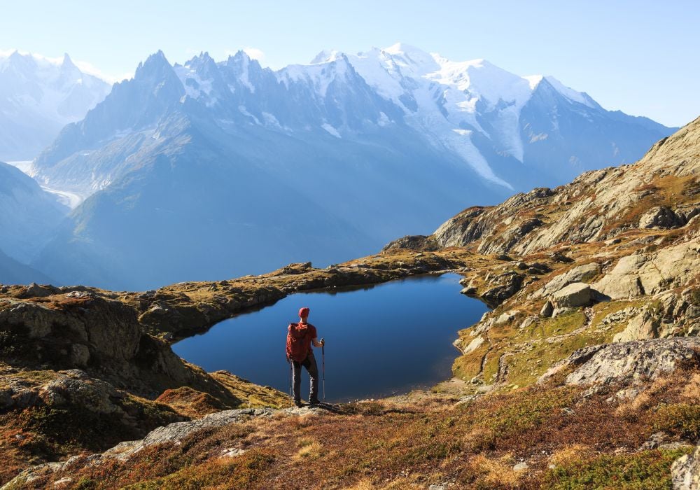 Hiker looking at Lac des Cheserys on the famour Tour du Mont Blanc near Chamoniz, France